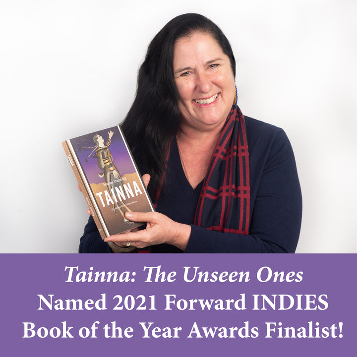 Inuk author Norma Dunning holds up her book, Tainna: The Unseen Ones. Below Norma is a purple banner that reads: Tainna: The Unseen Ones Names 2021 Forward INDIES Books of the Year Awards Finalist!